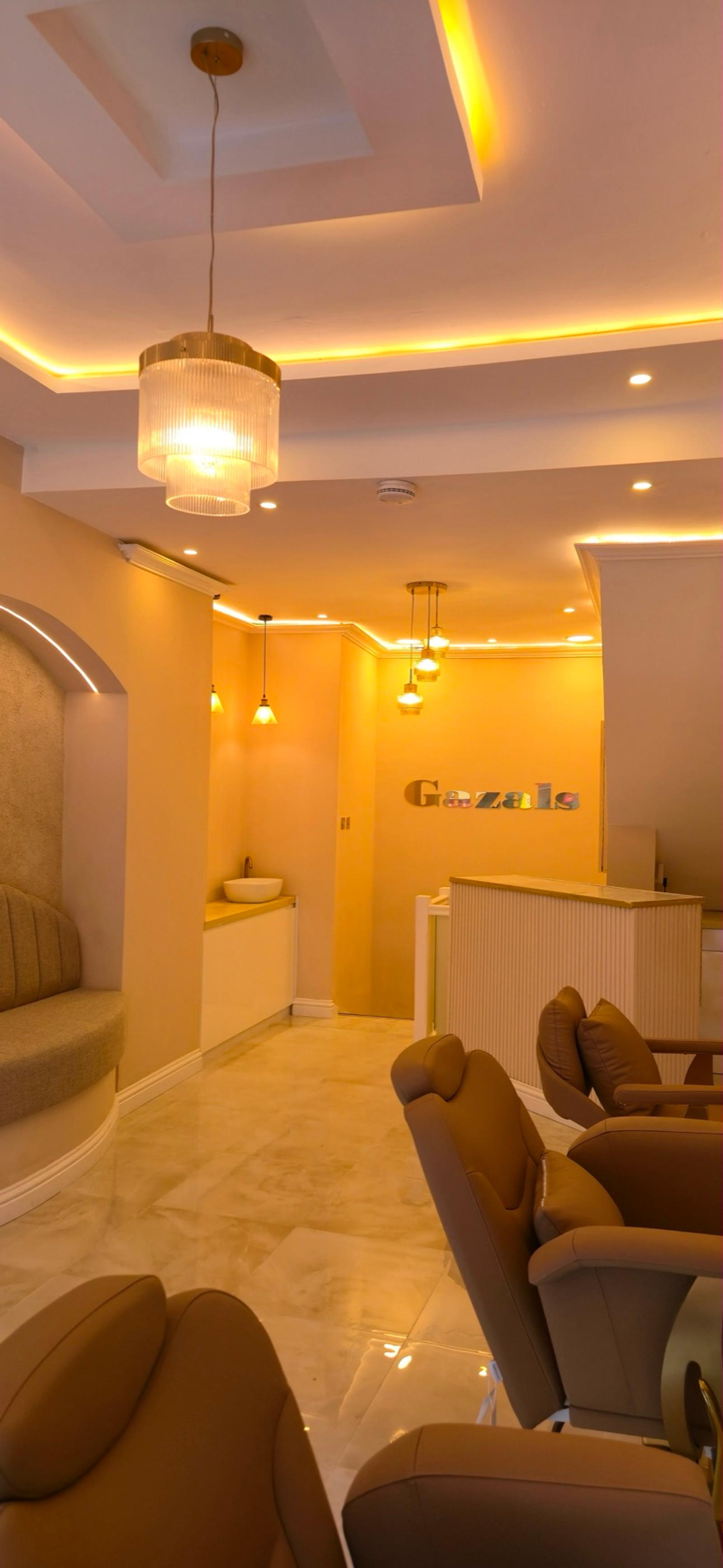 Reception desk beneath the gold Gazals wall sign